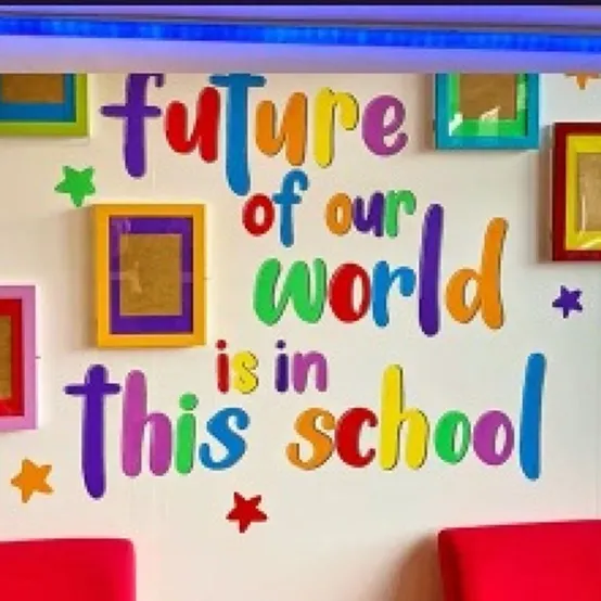 Bright classroom wall mural reading The future of our world is in this school