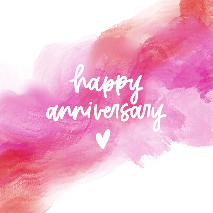 Hand lettered Happy Anniversary card design on a pink watercolour wash background