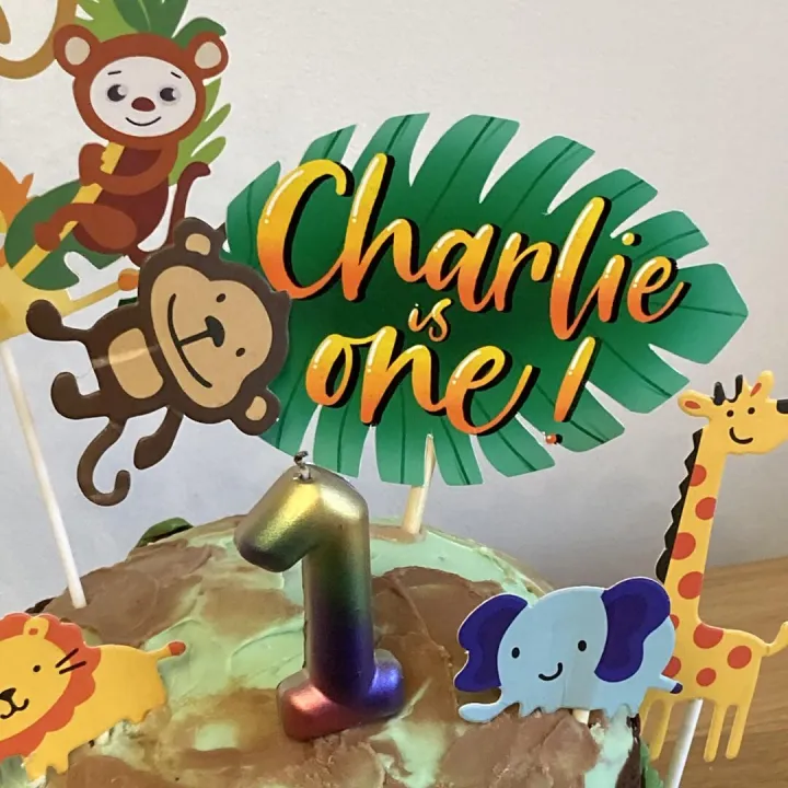 Printed personalised jungle theme cake topper for a first birthday, designed digitally with monkey and giraffe illustrations