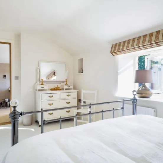 Bedroom two at Otters Retreat with a king size bed and its own en suite