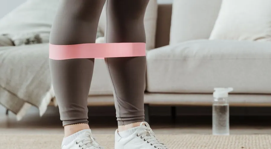 Resistance band worn around the ankles during exercise