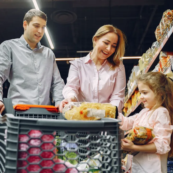 Family shopping together in a supermarket aisle