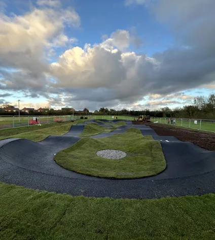 View of Battenhall Park pump track with dramatic sky