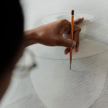 Close up of student hand holding pencil practicing sketching