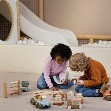 Full shot kids playing with eco toys indoors