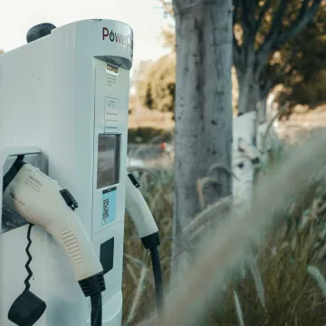 Electric vehicle charging station in an outdoor natural setting, highlighting sustainable technology.