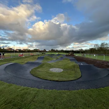 View of Battenhall Park pump track with dramatic sky