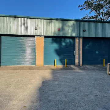 Industrial units with roller shutters and green roofs