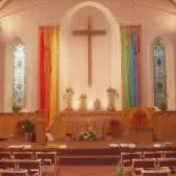 Inside the church, at the front