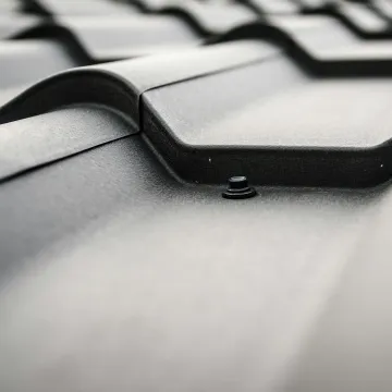 Detailed close-up of a black steel roof with promi