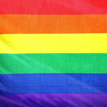 Close-up of a colorful rainbow flag symbolizing