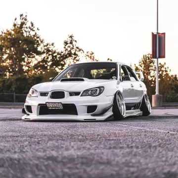 Low angle view of a white customized sports car pa