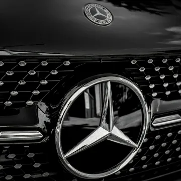 Detailed close-up of a Mercedes-Benz emblem on a