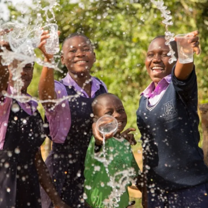 Members of St Balikddembe schools health club (SHC) enjoying the new water source – Copyright All We Can