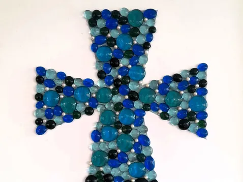 Framed glass cross made by the Friendly Faces group (2025)