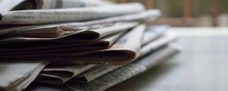A close-up of a stack of newspapers resting on a