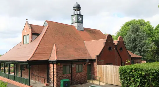 A picturesque brick building with a clock tower surrounded b