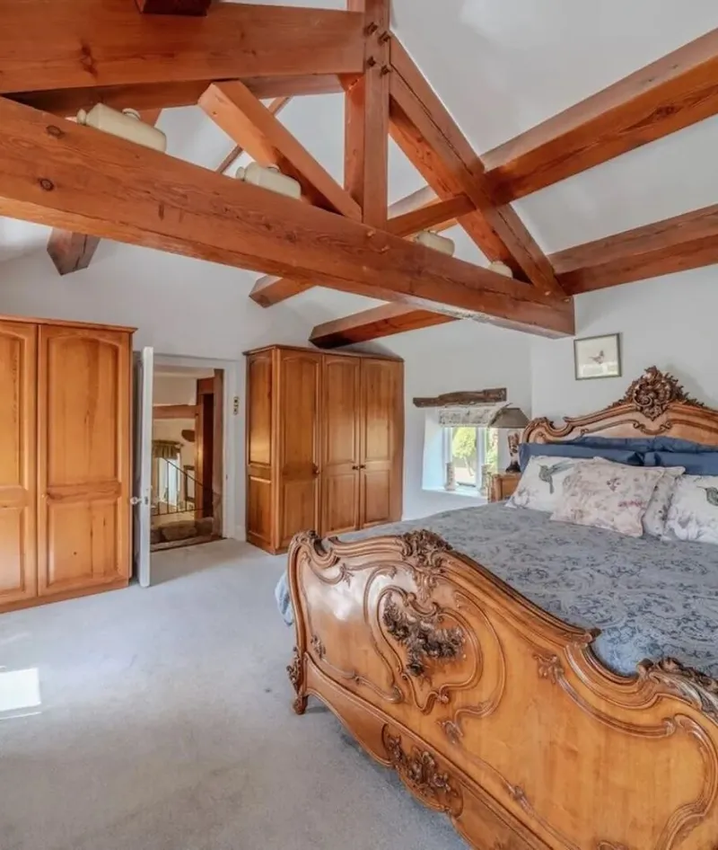 Bedroom one, a beamed room with a large French bed