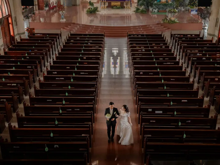 A newly married couple walking back down the aisle