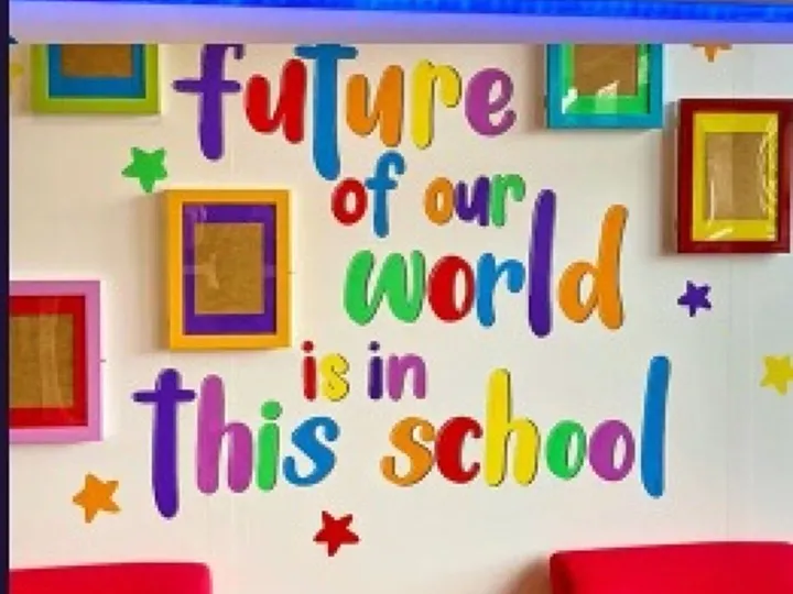 Bright classroom wall mural reading The future of our world is in this school