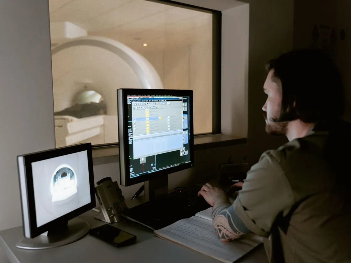 Clinician reviewing scans in an imaging control room