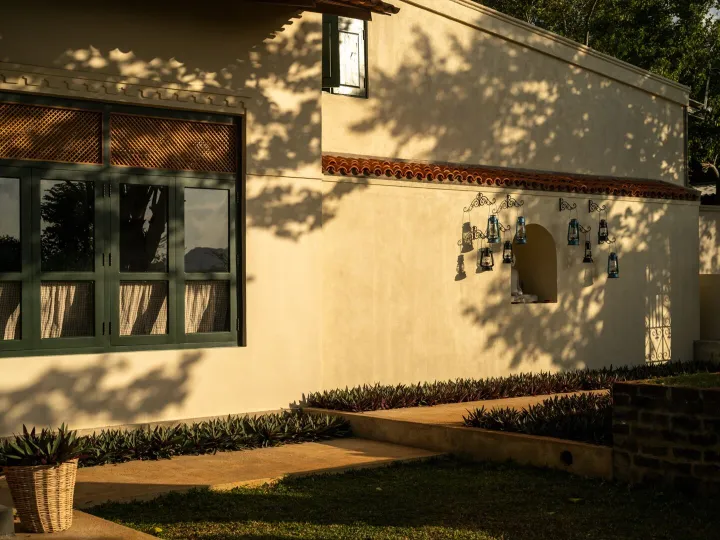 The whitewashed front elevation of the villa at Peacock Hill Sigiriya