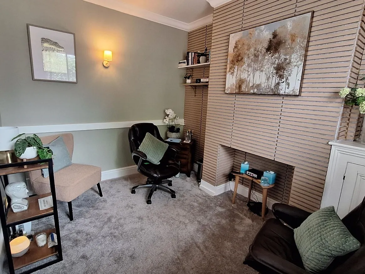 Wilmslow therapy room with armchairs, a desk chair and soft lighting
