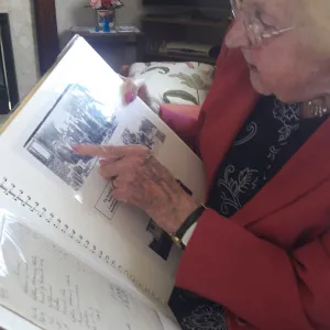 1 LEAFING THROUGH AN ALBUM DORISS PARENTS LEFT HER  DEPICTING THE CHAPELS SEMINAL MOMENTS