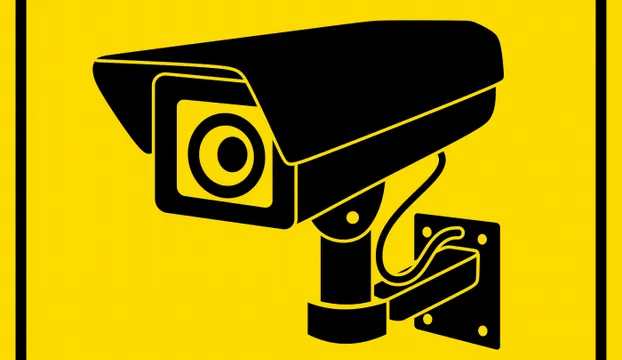 CCTV camera black on yellow