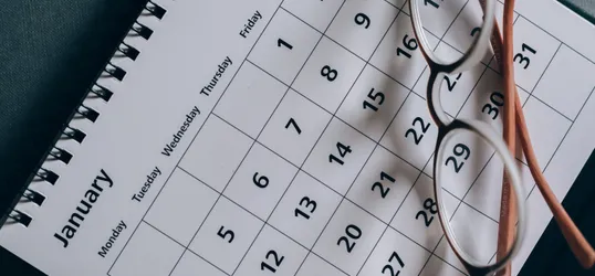 Brown-Framed Eyeglasses on a Calendar
