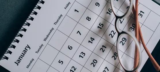 Brown-Framed Eyeglasses on a Calendar