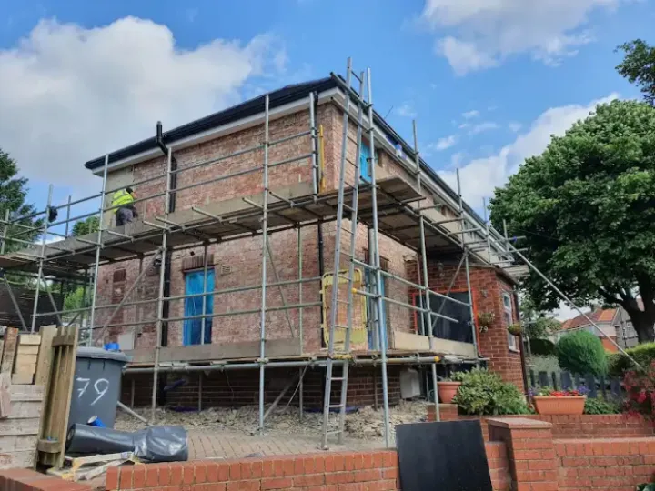 Scaffold around house undergoing rendering