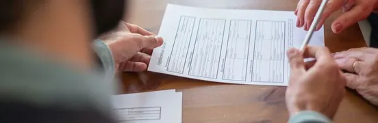 An Agent Handing a Pen to a Client