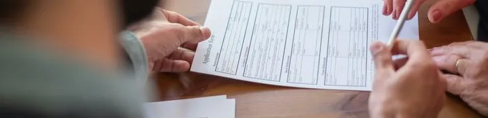 An Agent Handing a Pen to a Client