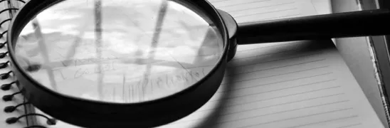 Magnifying glass, journal, detail