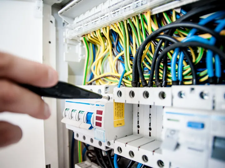 Electrician working on an electric circuit board