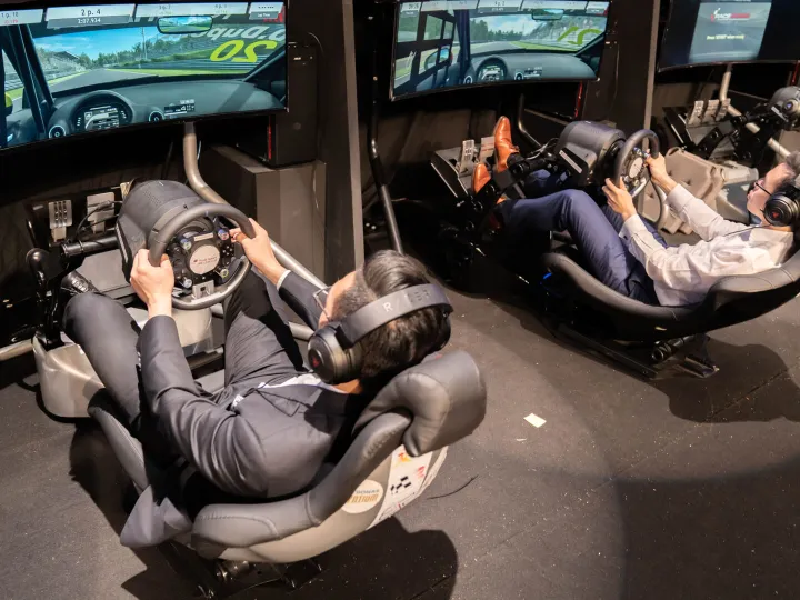 Two drivers in racing simulator rigs