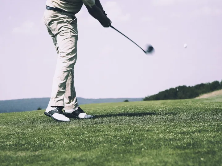 Golfer teeing off on the fairway