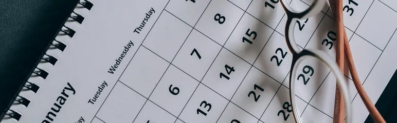 A close-up of a January calendar with eyeglasses
