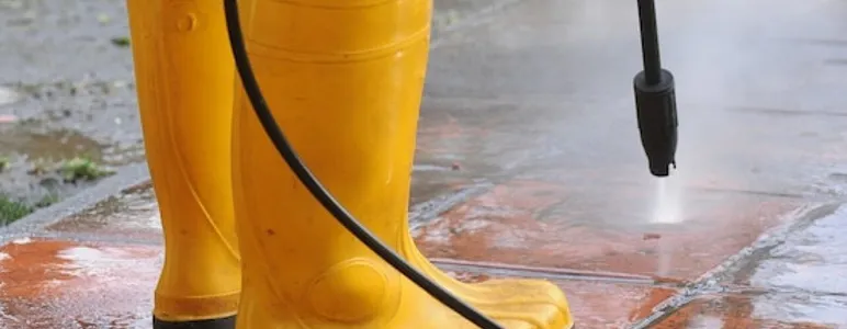 Person wearing yellow rubber boots with