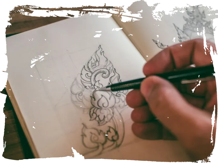 A designer sketching detailed drawings in a notebook