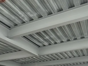 Large empty industrial space with metal roof