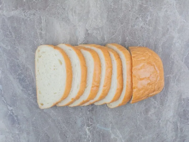 Sliced of fresh bread on marble background.