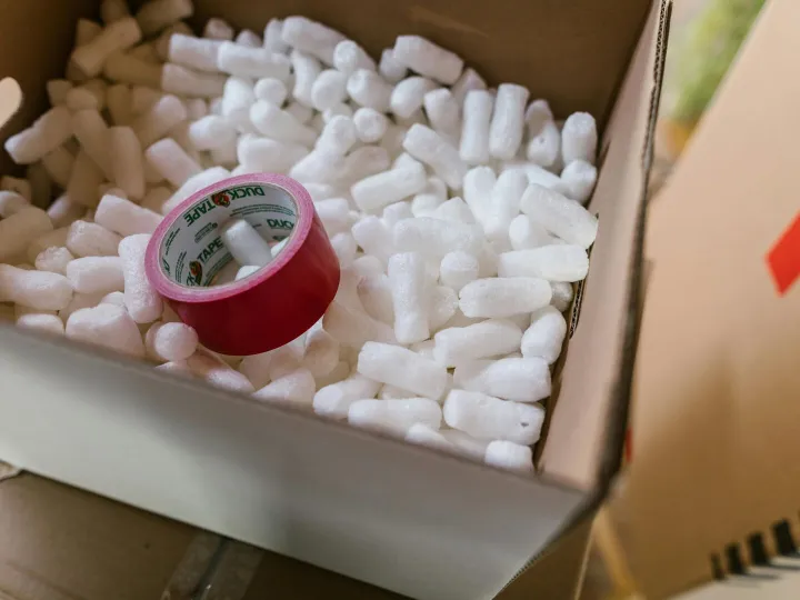 Close-up of a cardboard box filled with packing pe