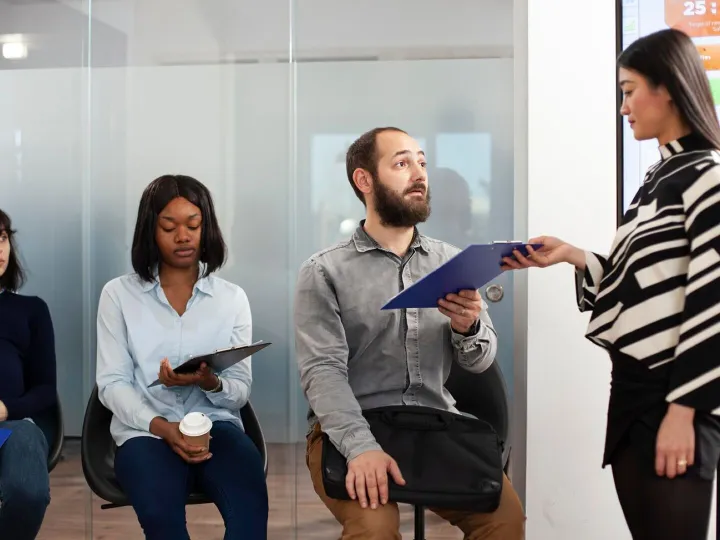 Recruiter taking cv from male applicant