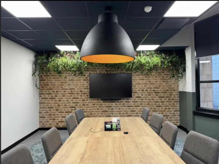 A Manchester office meeting room with a large overhead lamp