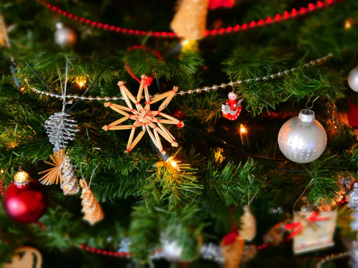 Close-up of a decorated Christmas tree with lights and ornaments, showcasing holiday spirit.