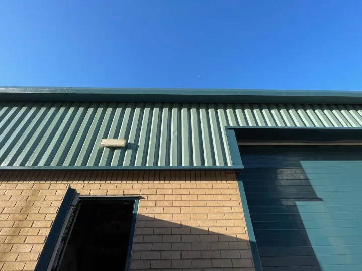 Close-up of green-roofed warehouse building