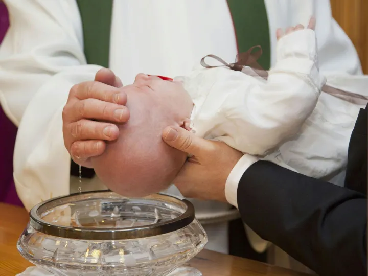 A baby being baptized during a ceremonial