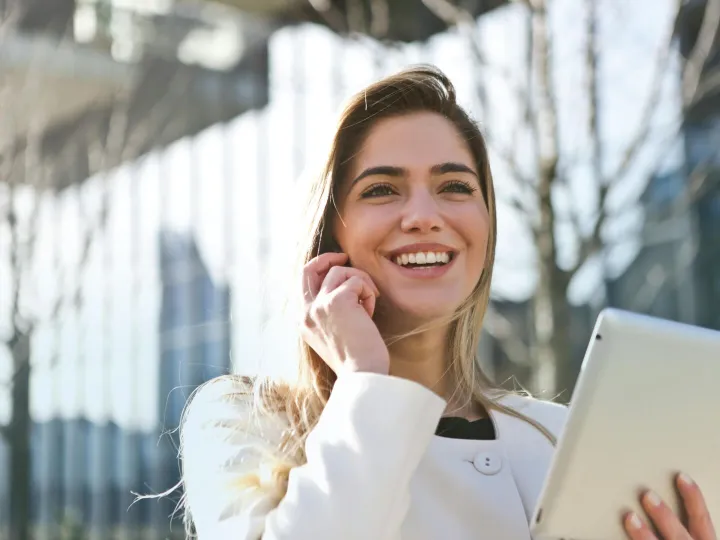 Confident businesswoman using her tablet and phone